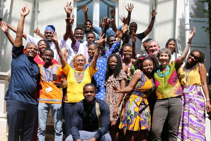 Christine Travers, Director of IFP School, and the school staff, alongside students in the colors of Africa.